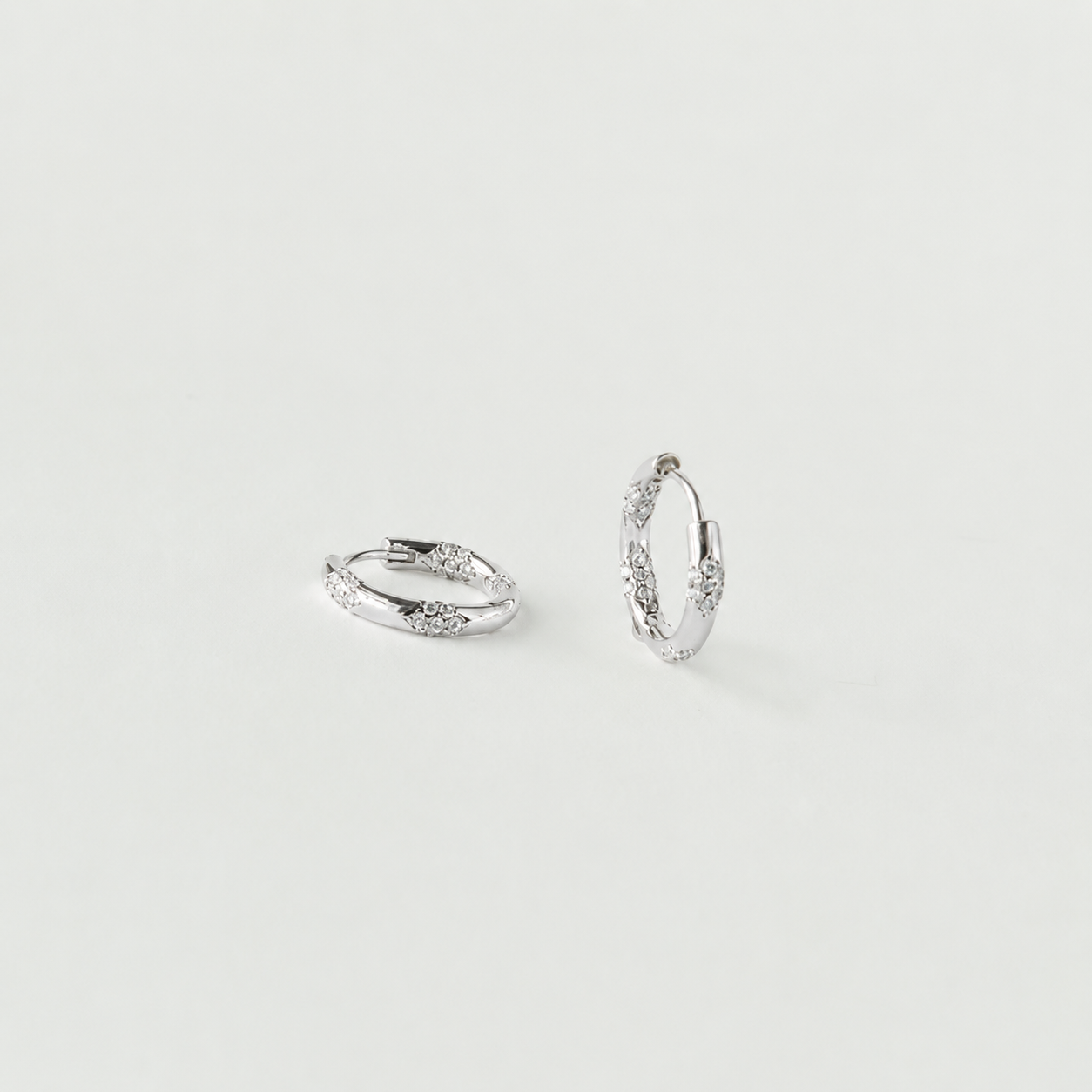 Pair of silver hoop earrings on a light gray background
